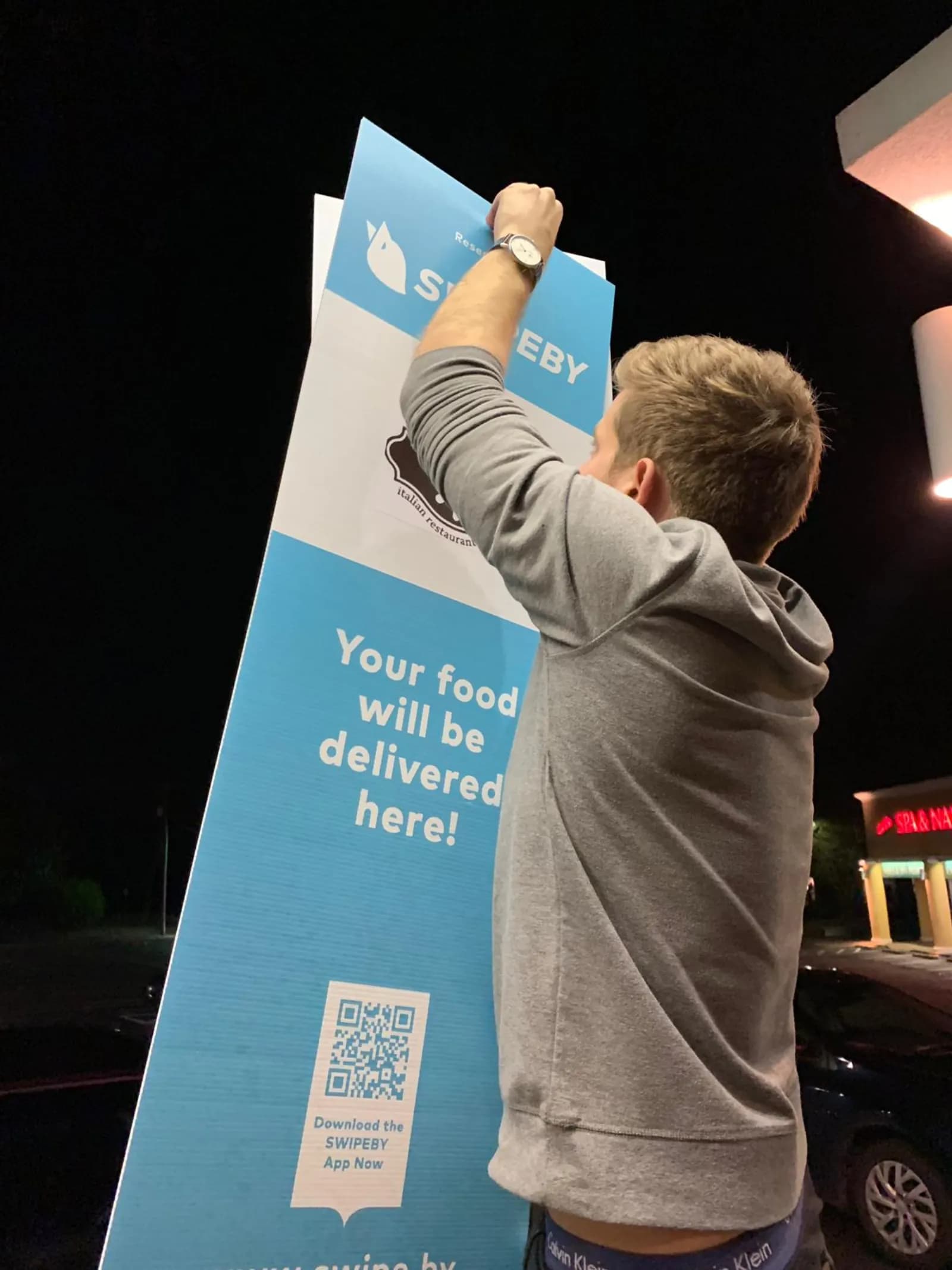 Installing SWIPEBY curbside sign