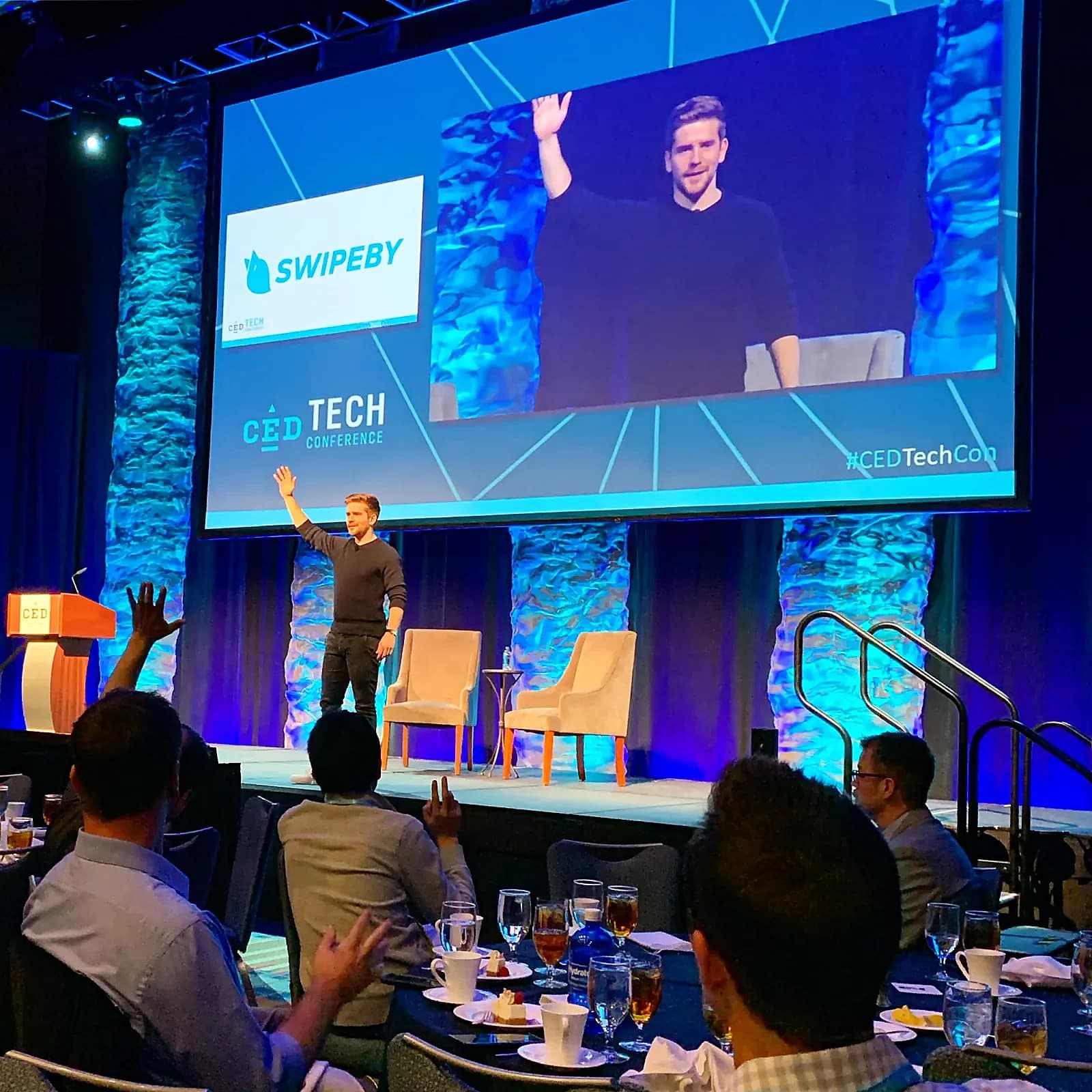 SWIPEBY founder on stage at a tech conference